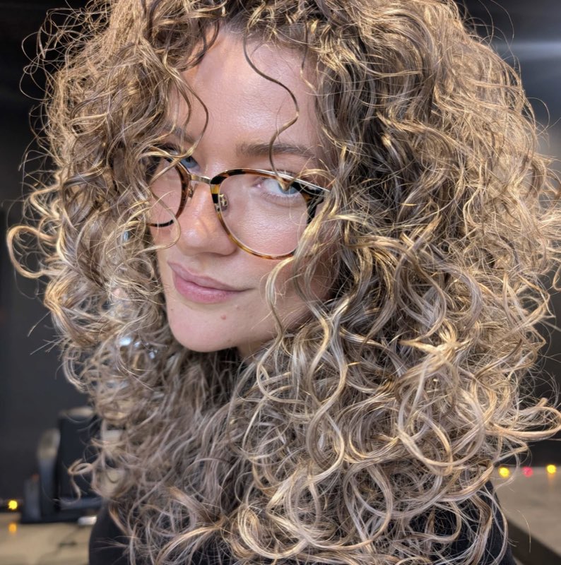 Defined spiral curls with soft dimensional blonde colour